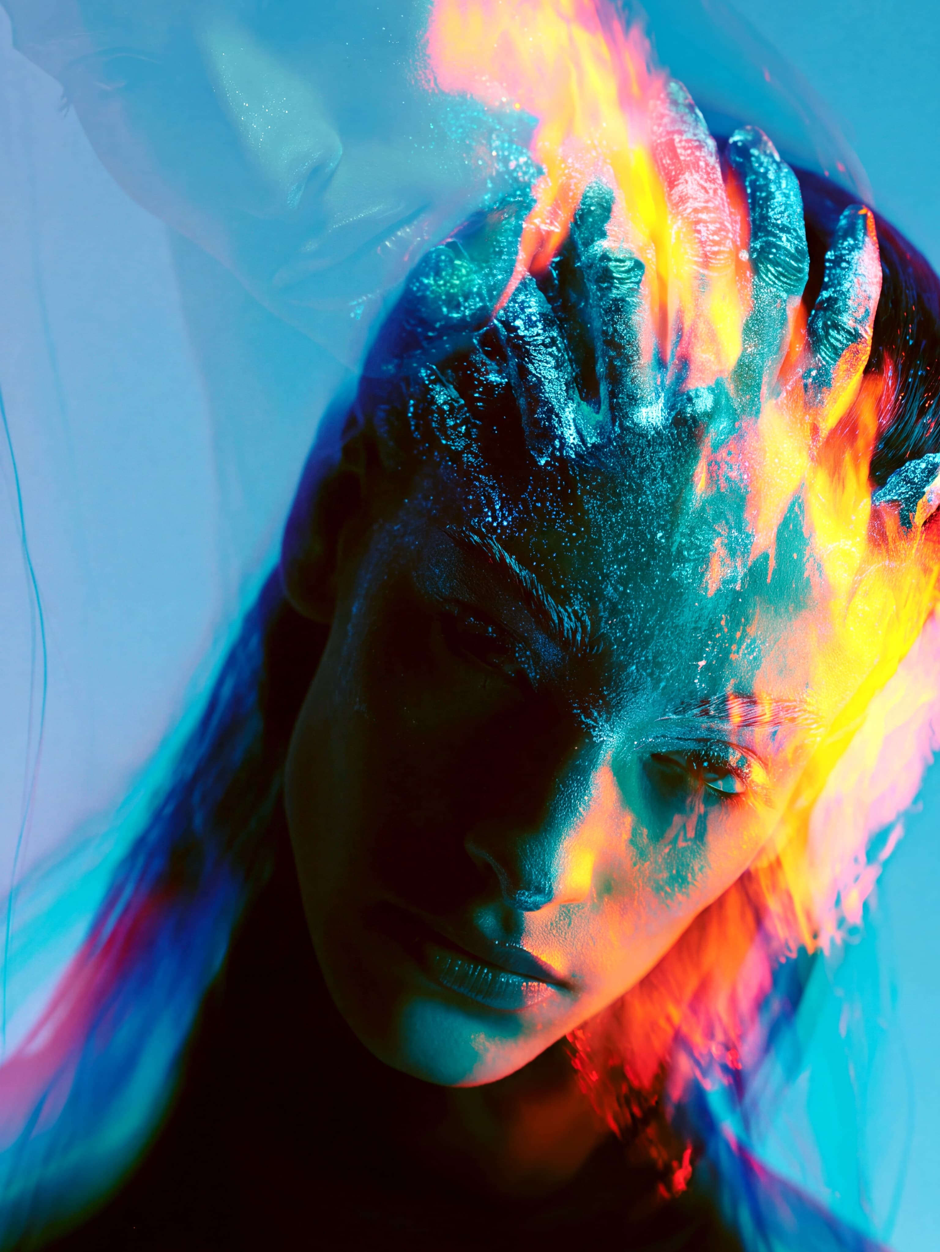 Projection reference portrait with blue and orange light across a face against a vivid cyan background